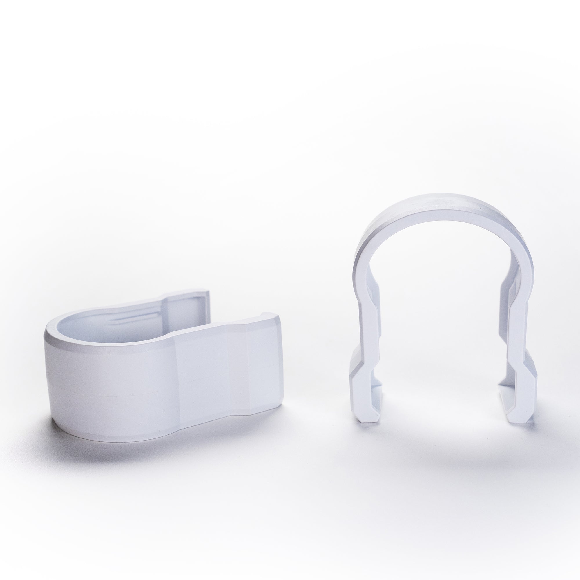 Two Faven under canopy light couplings next to each other on a white background. One coupling is laying down and the other is right side up.